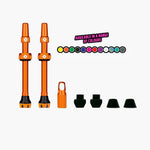Orange Muc-Off tubeless valve kit with valves and accessories on white background