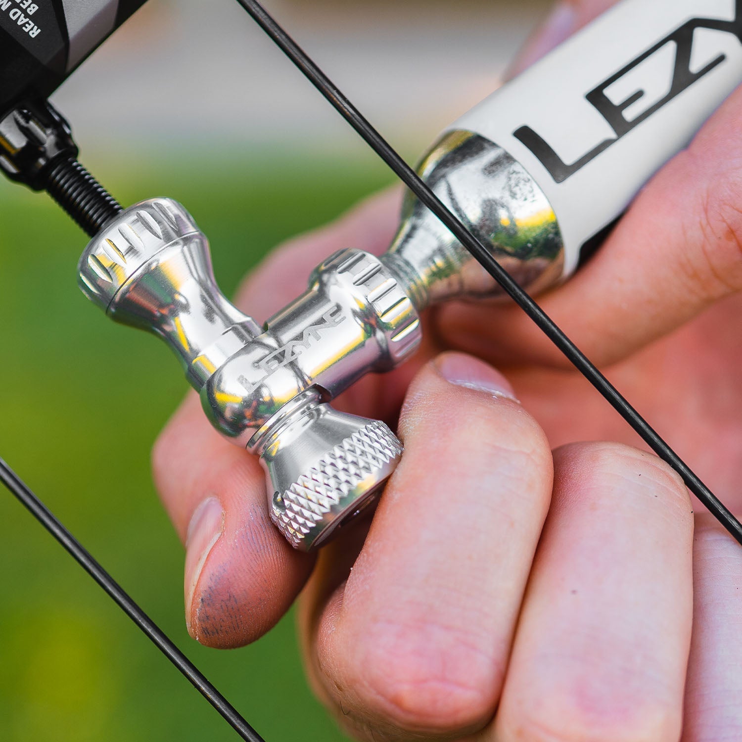 Lezyne Control Drive CO2 head held in hand showing silver chrome finish