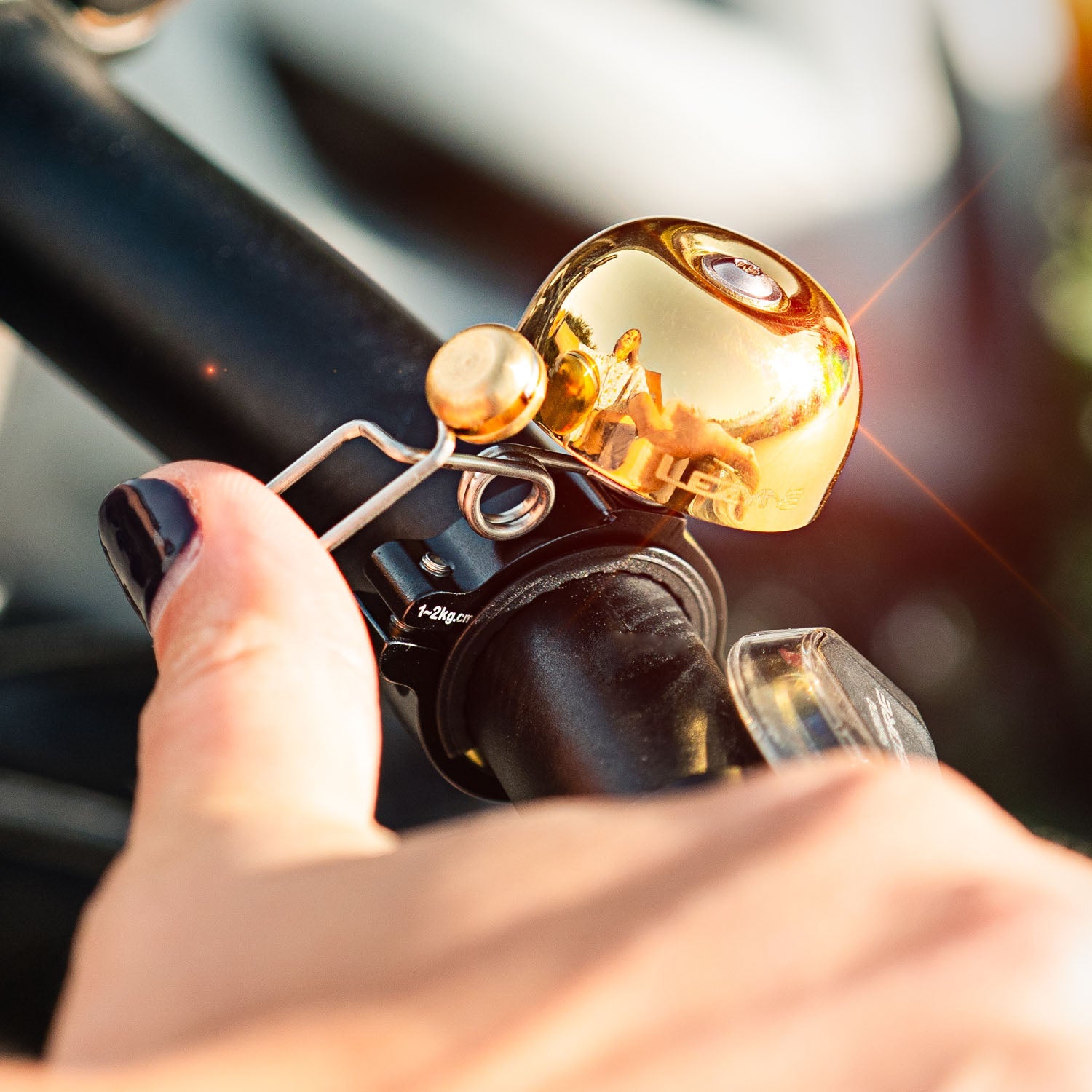 Lezyne Classic Brass Bell mounted on bicycle handlebar with golden finish
