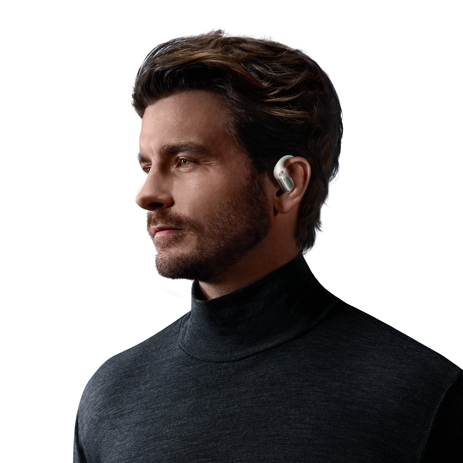 Man wearing white Shokz OpenFit Pro wireless earbuds in professional studio portrait