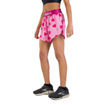 Woman wearing pink ChicknLegs split shorts with red heart pattern and athletic shoes