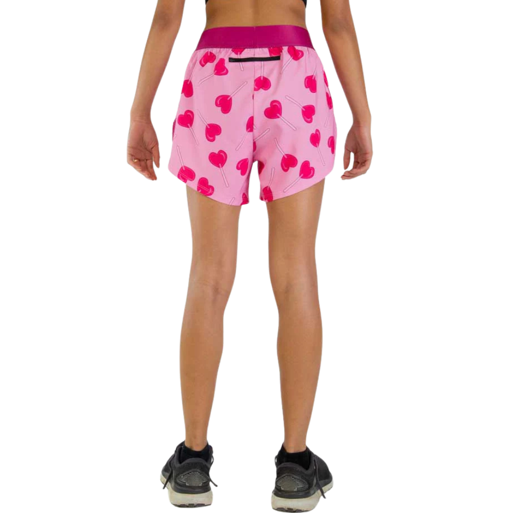 Pink athletic shorts with cherry pattern on model from behind