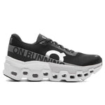 On Cloudmonster 2 running shoe in black with white sole and brand lettering