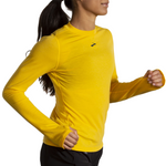 Brooks High Point Long Sleeve in Lemon Chrome yellow worn by female runner in motion