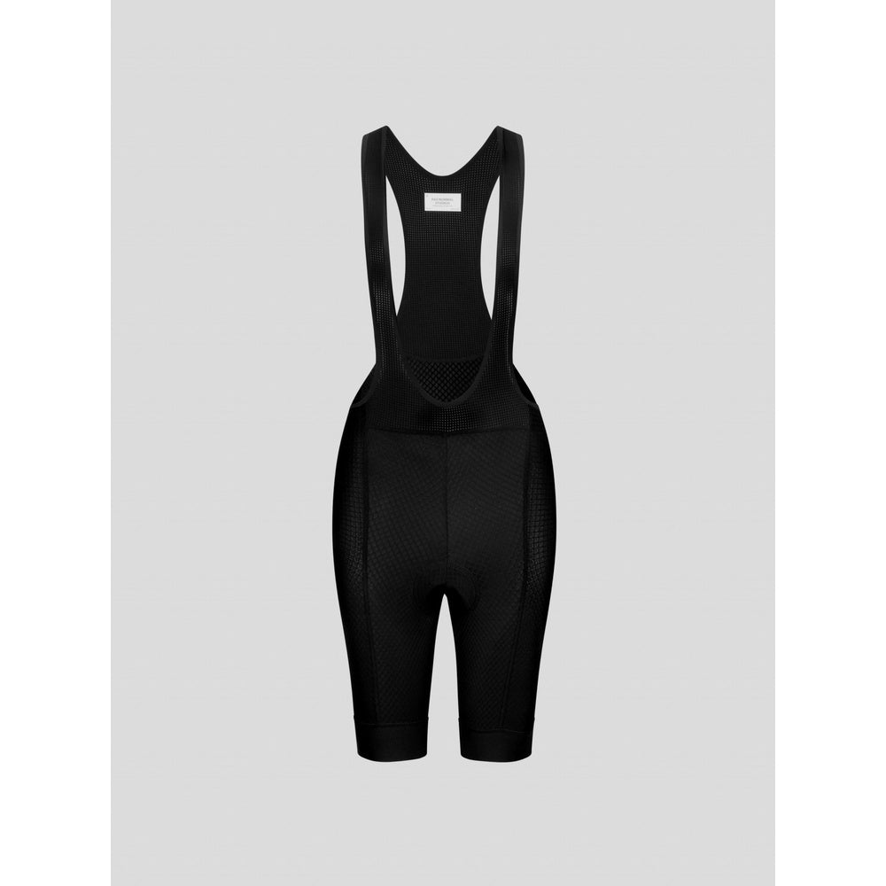 Black cycling bib shorts with mesh straps and padding on gray background