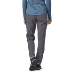 Woman wearing Patagonia Quandary pants in forge grey with hiking boots