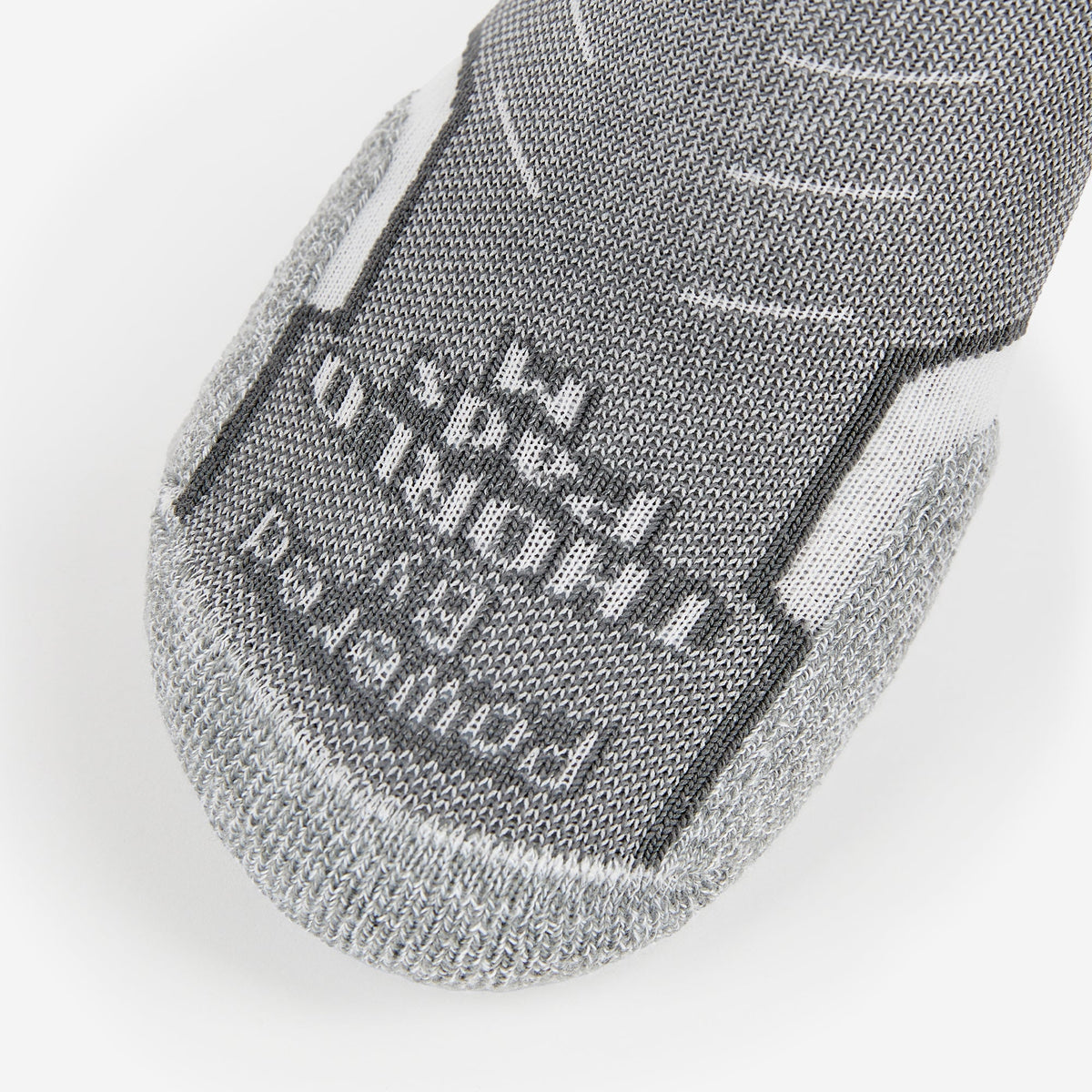 Thorlos Experia Energy sock toe closeup showing gray knit fabric with brand logo detail