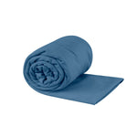 Sea To Summit Pocket Towel in moonlight blue, partially rolled with one end extended