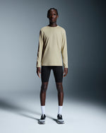 Man wearing beige On Focus-T long-sleeve shirt with black shorts and sneakers