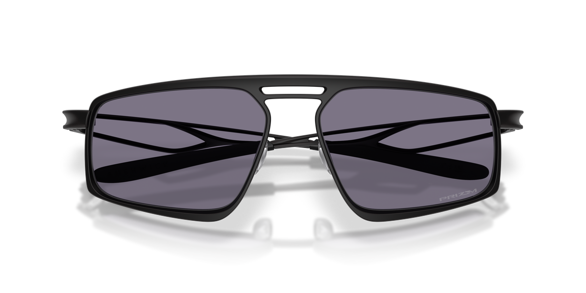 Oakley Bushwick sunglasses folded front view showing crossed temples and grey Prizm lenses