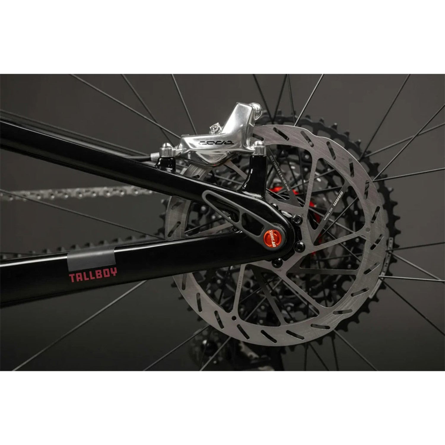 Close-up of Santa Cruz Tallboy black bike rear wheel with disc brake and derailleur