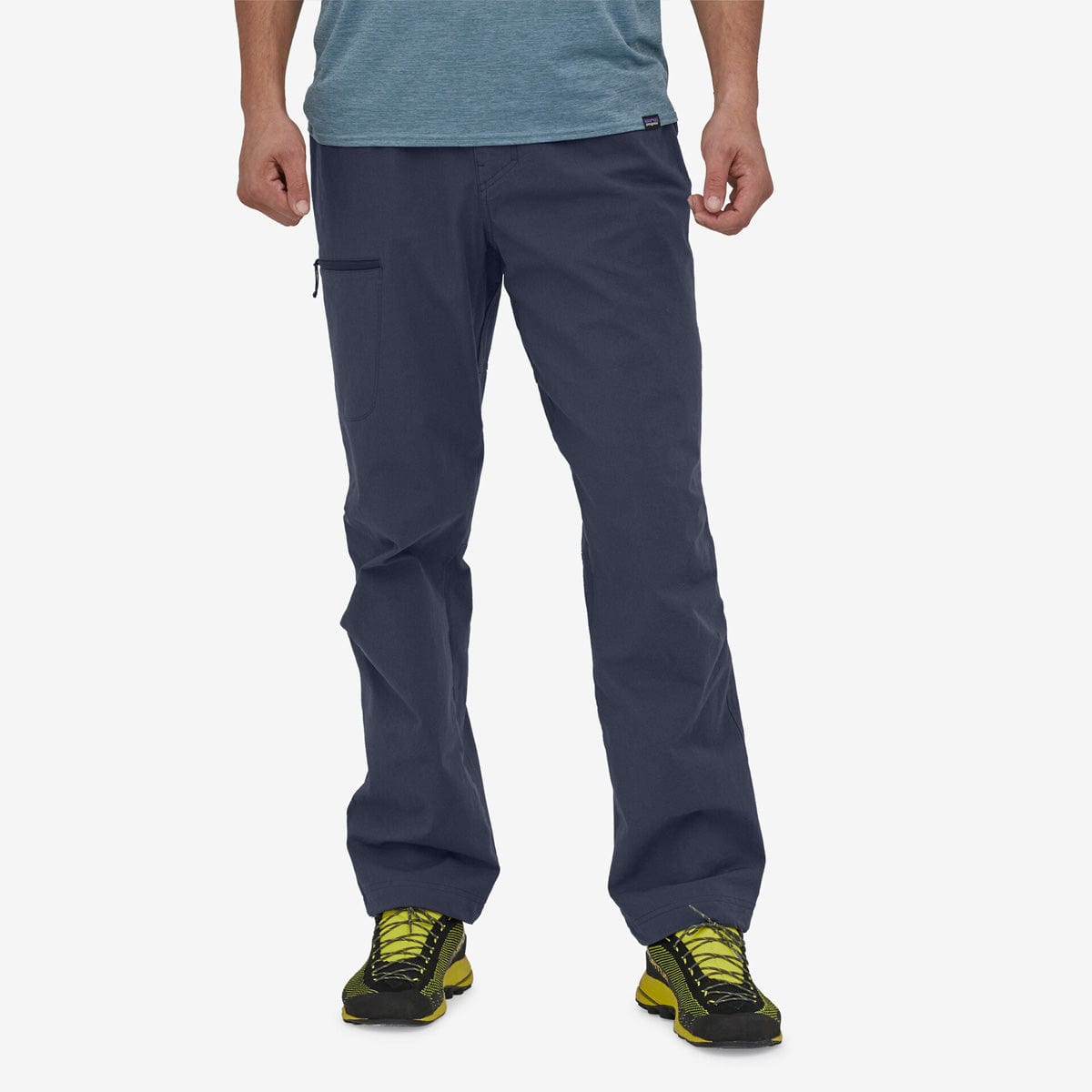Man wearing Patagonia Venga Rock Pants in navy blue with hiking shoes