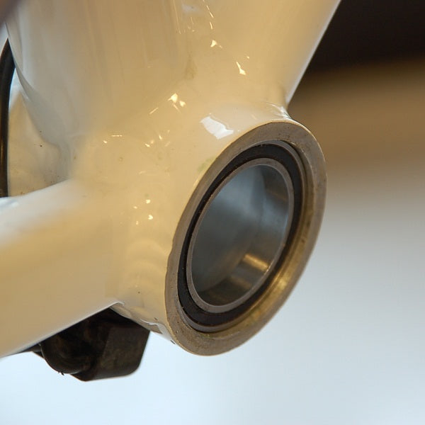 Wheels Manufacturing BB30 bottom bracket adaptor showing bearing and cream colored housing