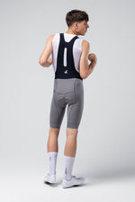 Gobik Absolute 7.0 bib shorts in Kettle gray shown from rear on male model