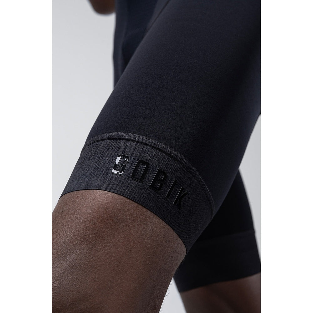 Close-up of black Gobik cycling bib shorts showing leg band with brand logo