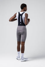 Man wearing gray Gobik Absolute Compact 7.0 cycling bib shorts with white tank top