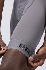 GOBIK gray cycling bibshorts shown on model with professional studio lighting
