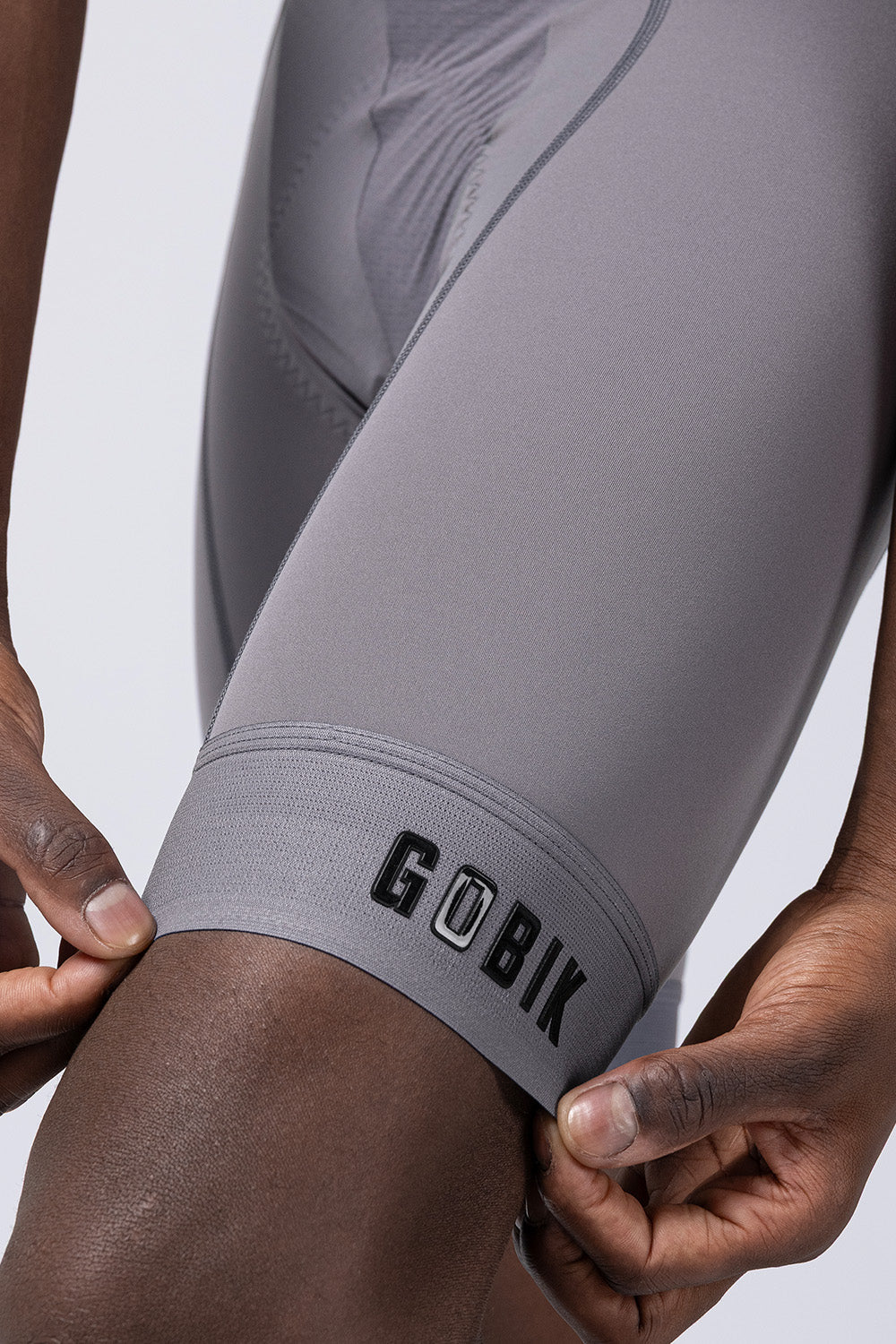 GOBIK gray cycling bibshorts shown on model with professional studio lighting