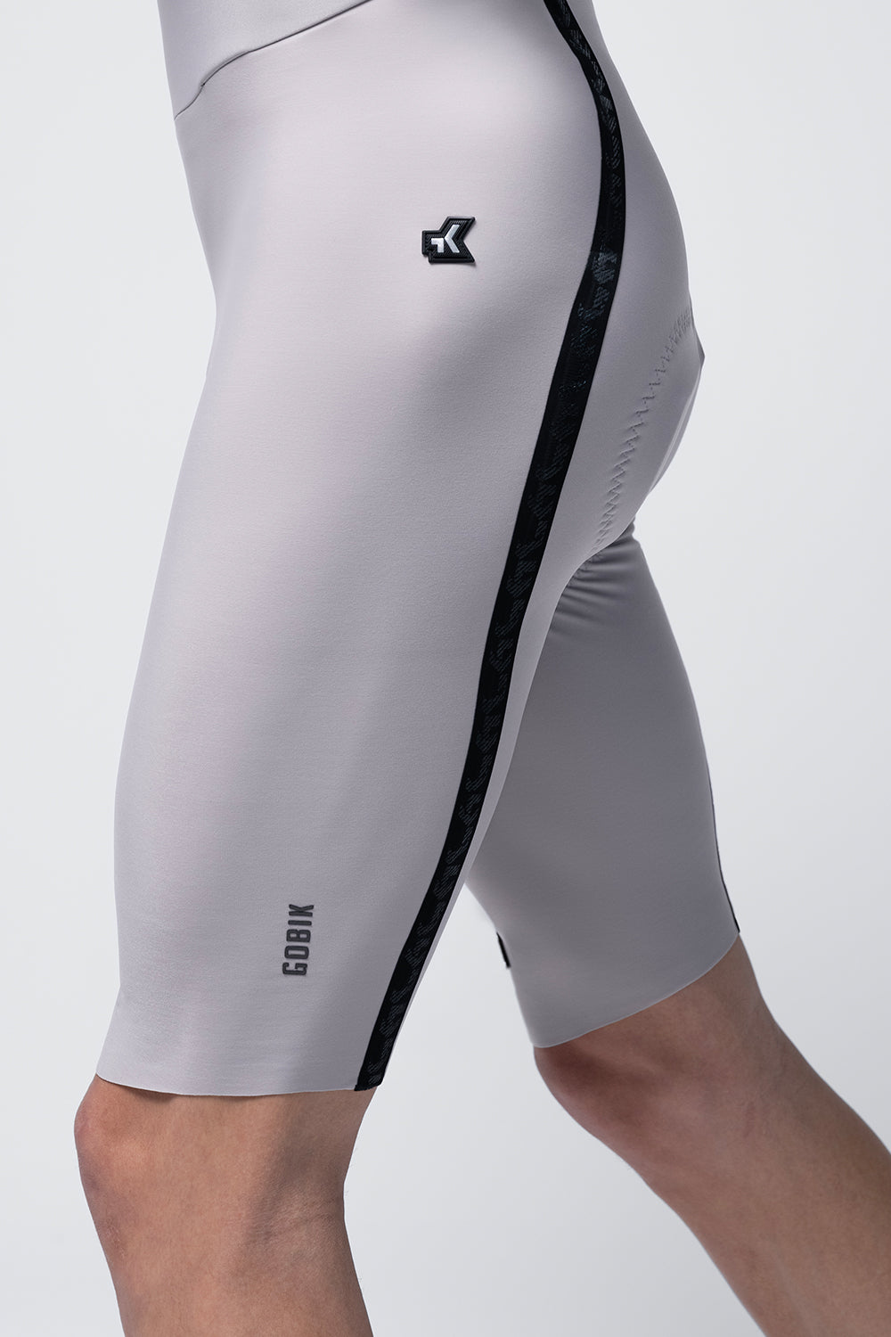 Close-up detail of Gobik Artic Stride bib shorts side panel with black stripe and Gobik logo