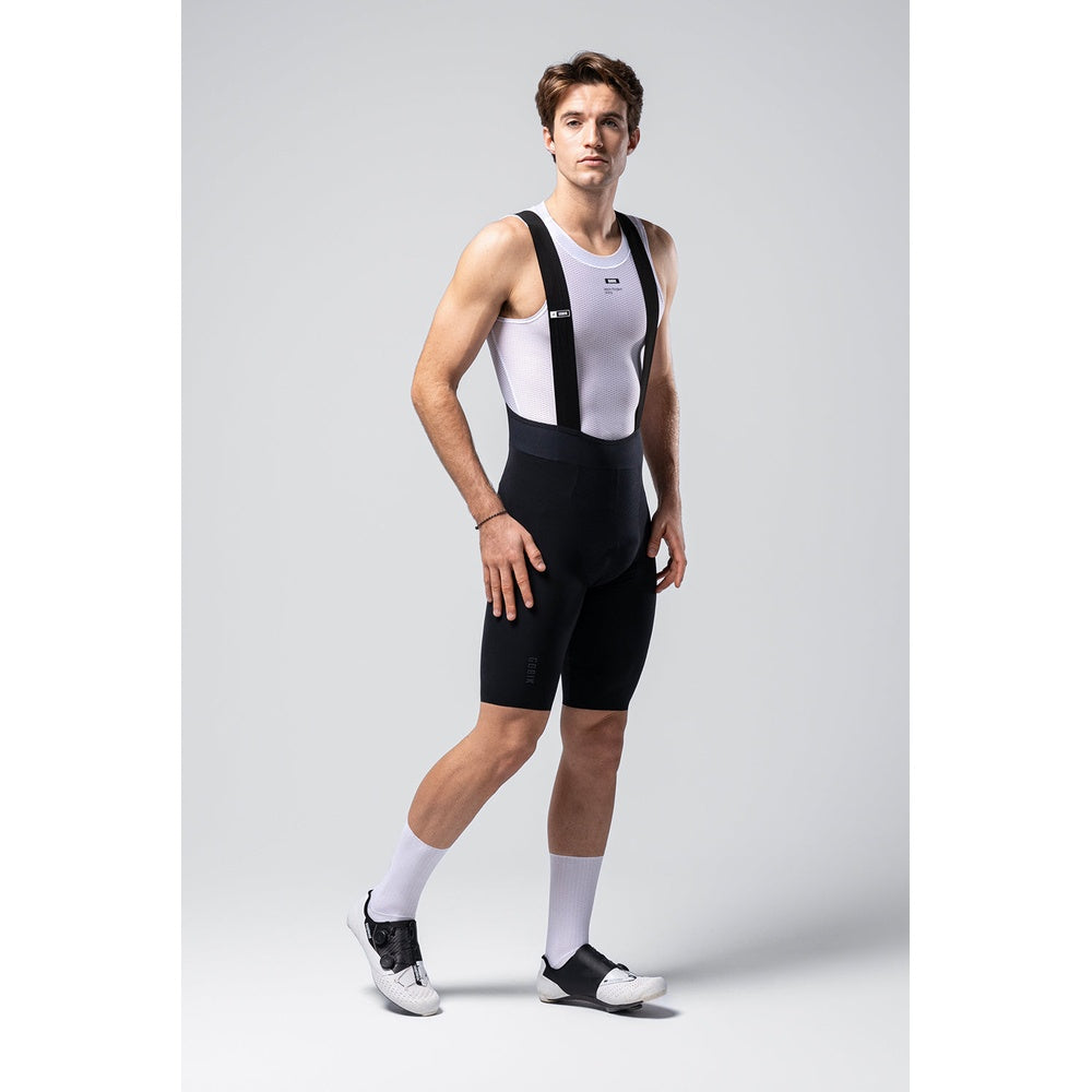 Male cyclist wearing Gobik Lancer black bib shorts with white mesh tank top