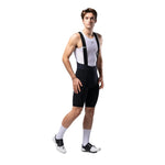 Male cyclist wearing Gobik Lancer black bib shorts with white mesh tank top