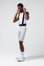 Male model wearing white Gobik Lancer bib shorts with mesh bib straps