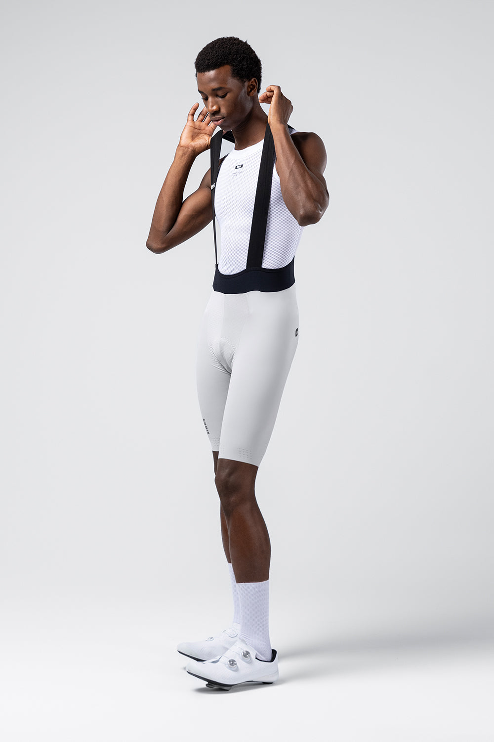 Male model wearing white Gobik Lancer bib shorts with mesh bib straps