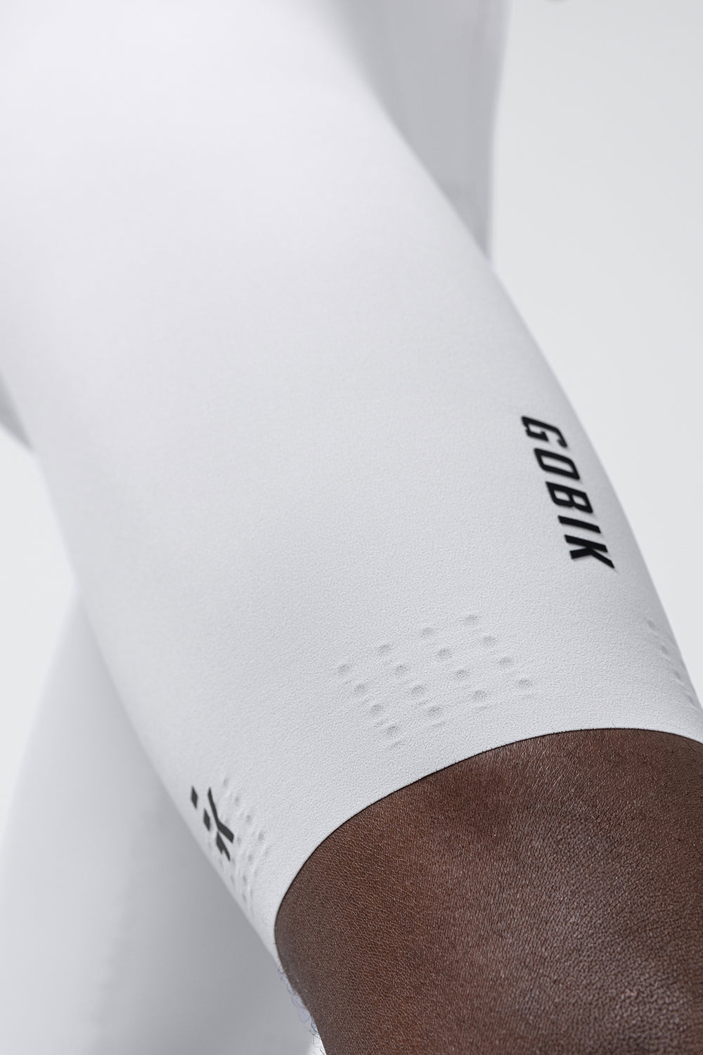 Gobik white cycling bib shorts with perforated ventilation panels and brown chamois interior