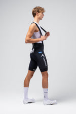 Male cyclist wearing Gobik Limited 6.0 bib shorts in Movistar team colors