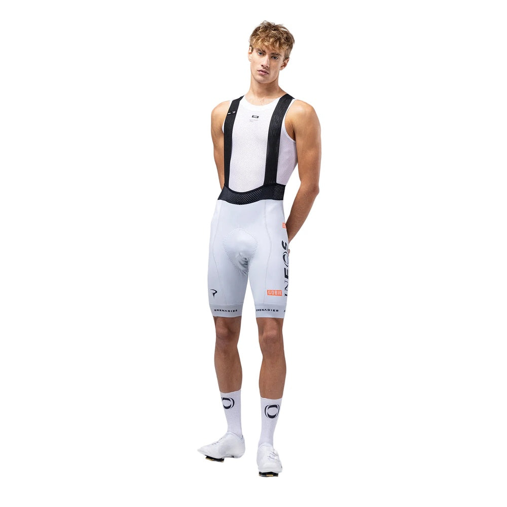 Male model wearing white Gobik Ineos Grenadiers cycling bib shorts with team branding