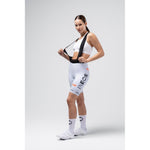 Woman modeling white Gobik Ineos Grenadiers cycling bib shorts with team logos