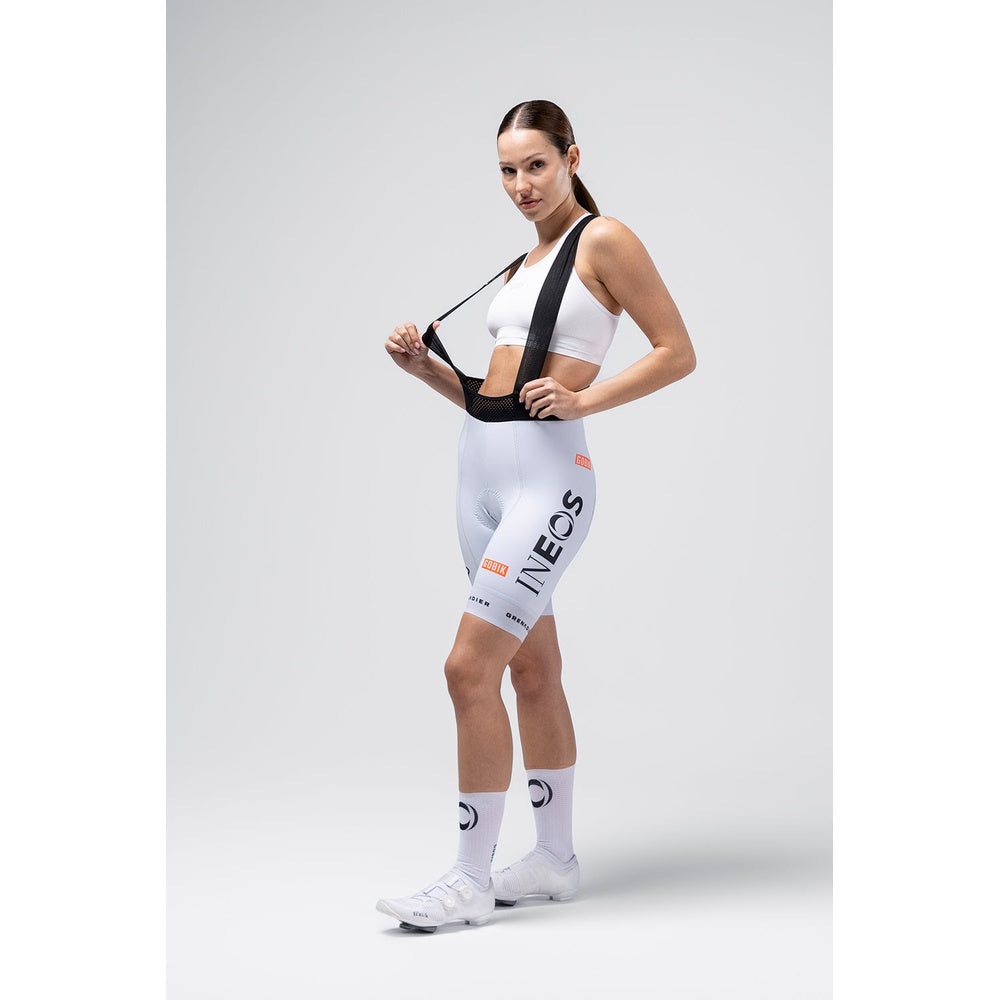 Woman modeling white Gobik Ineos Grenadiers cycling bib shorts with team logos