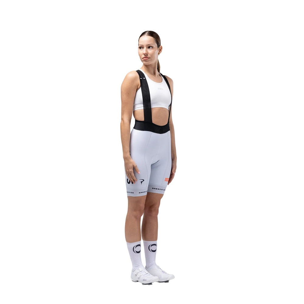 Woman wearing Gobik Ineos Grenadiers light blue cycling bib shorts with team branding