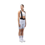 Woman wearing Gobik Ineos Grenadiers light blue cycling bib shorts with team branding