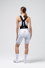 Woman wearing white Gobik Limited Print Bib Short with TotalEnergies Ineos Grenadiers team design