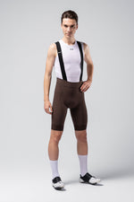 Man wearing Gobik Matt 2.0 bib shorts in cocoa brown with white base layer