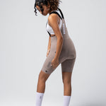 Woman wearing Gobik Matt 2.0 bib shorts in taupe color with white sports bra