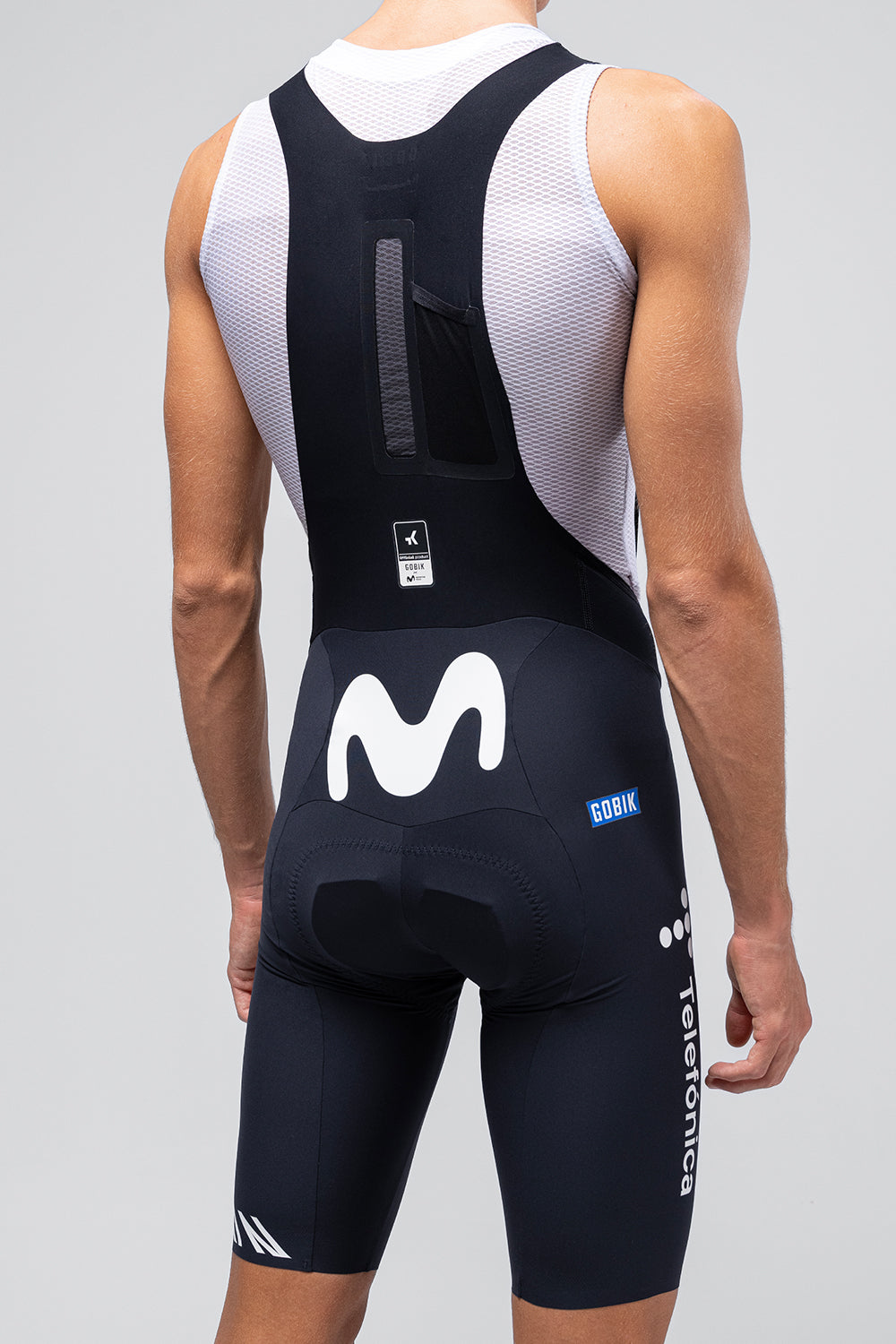 Gobik Ultralite bib shorts in Movistar team colors, rear view showing navy with white M logo
