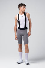 Male cyclist wearing grey Gobik X bib shorts with white base layer