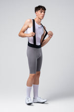 Male cyclist wearing grey Gobik X bib shorts with white mesh base layer