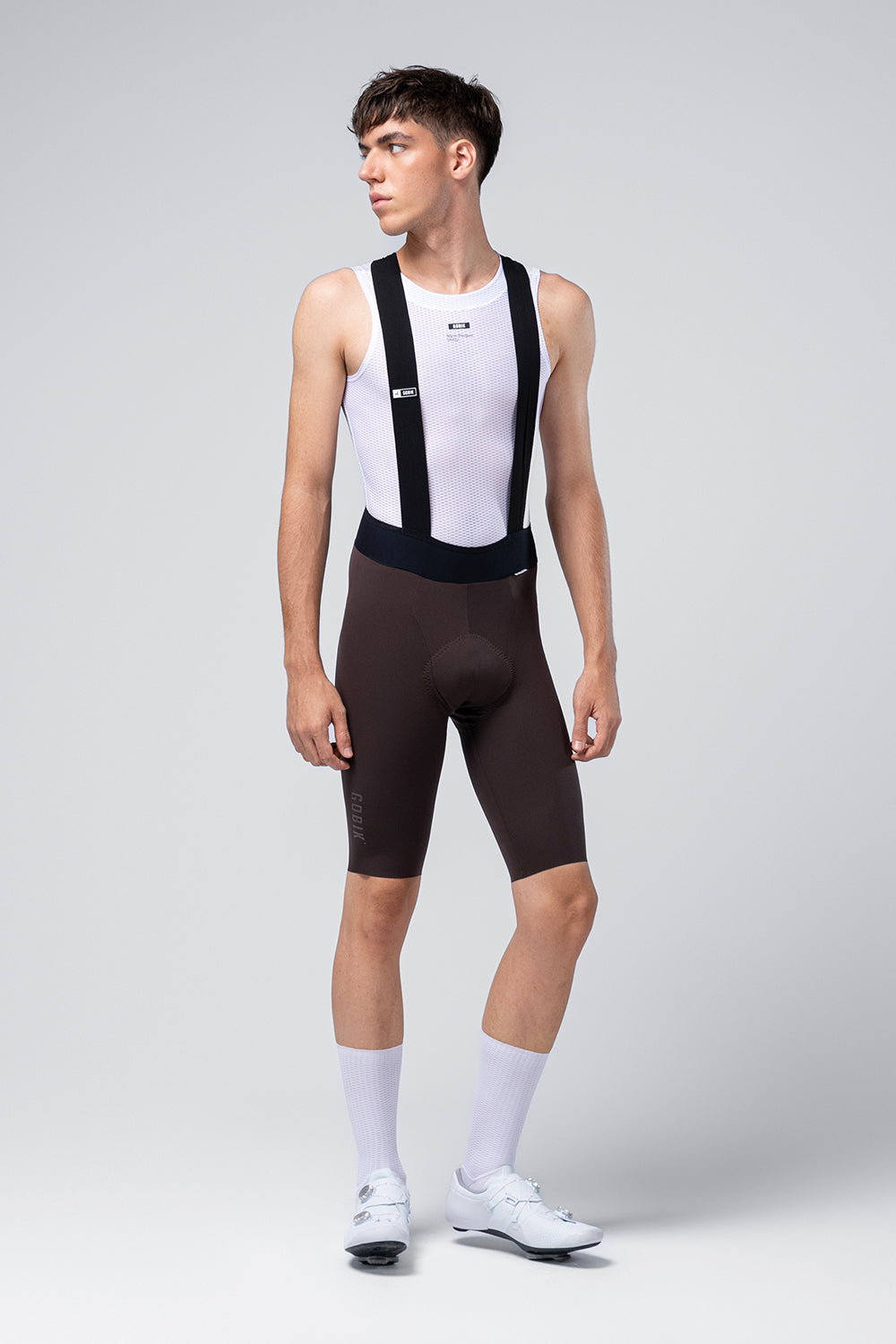 Male cyclist wearing black Gobik X bib shorts with white jersey and socks