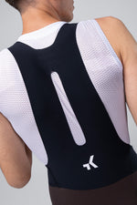 Back view of man wearing Gobik X black cycling bib shorts with white mesh panels