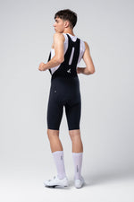 Male cyclist wearing Gobik X Bib Short in navy blue with white jersey