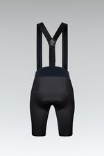 Gobik X women's cycling bib shorts in black with navy panel and suspenders