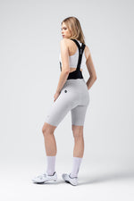 Woman wearing Gobik X Bib Short in light gray with black straps