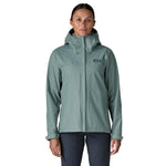 Woman wearing Patagonia Torrentshell 3L jacket in sage green color on white background