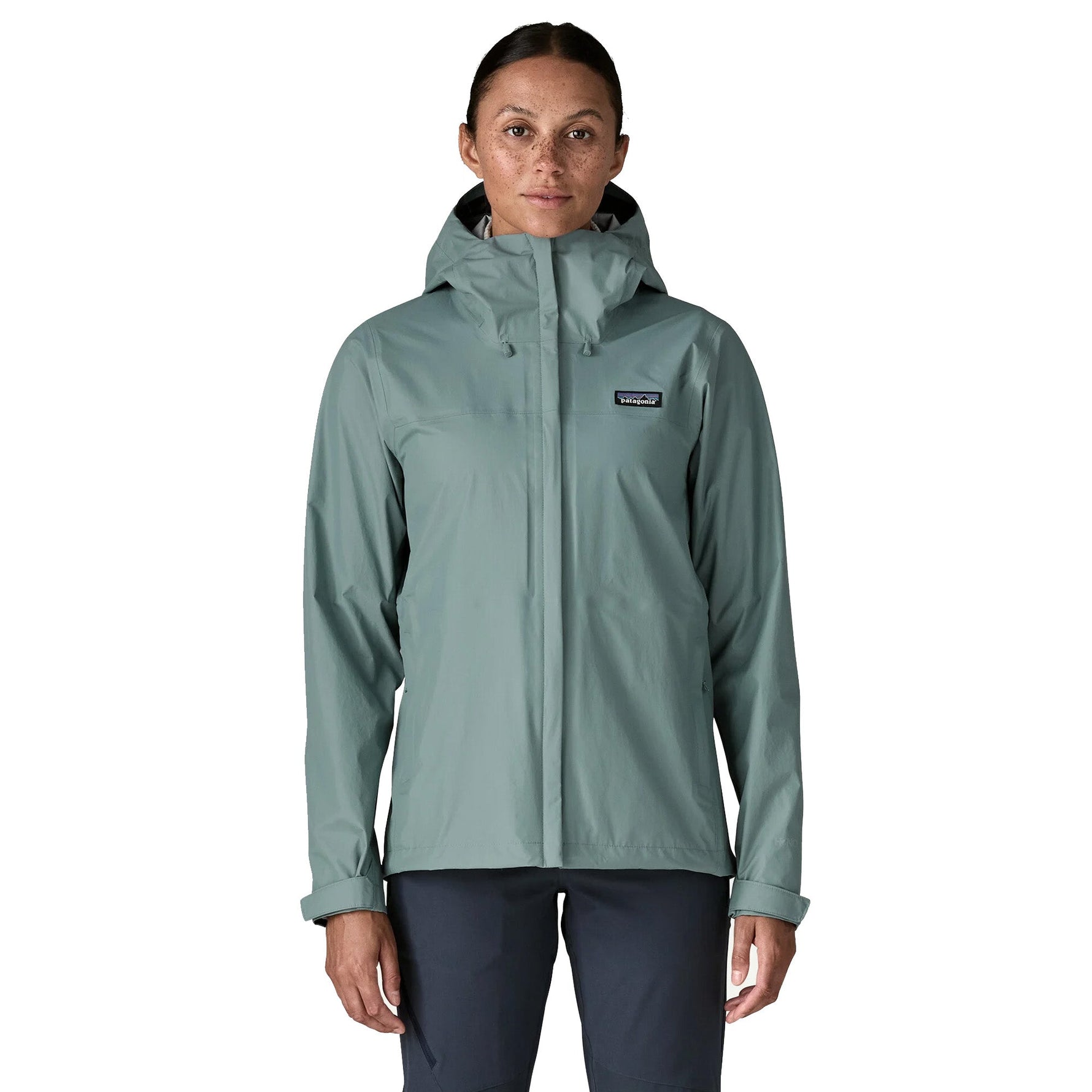 Woman wearing Patagonia Torrentshell 3L jacket in sage green color on white background