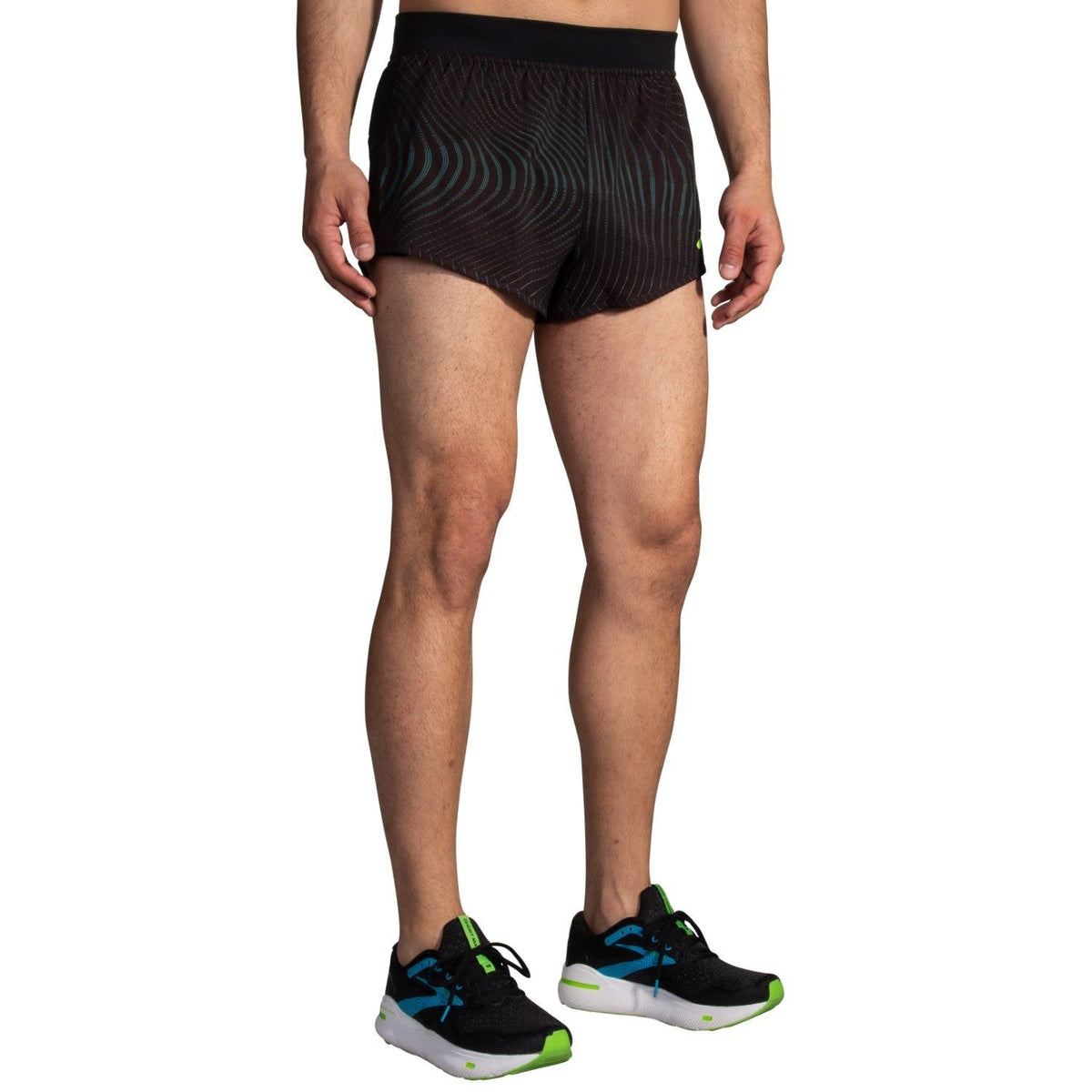Brooks Sherpa 3-inch Split Short in Surge colorway worn by male model with matching Brooks running shoes