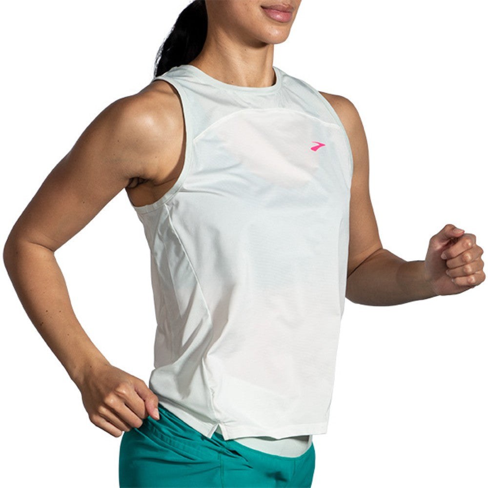 Woman running in Brooks Sprint Free Tank 2.0 sleeveless top in light white mint