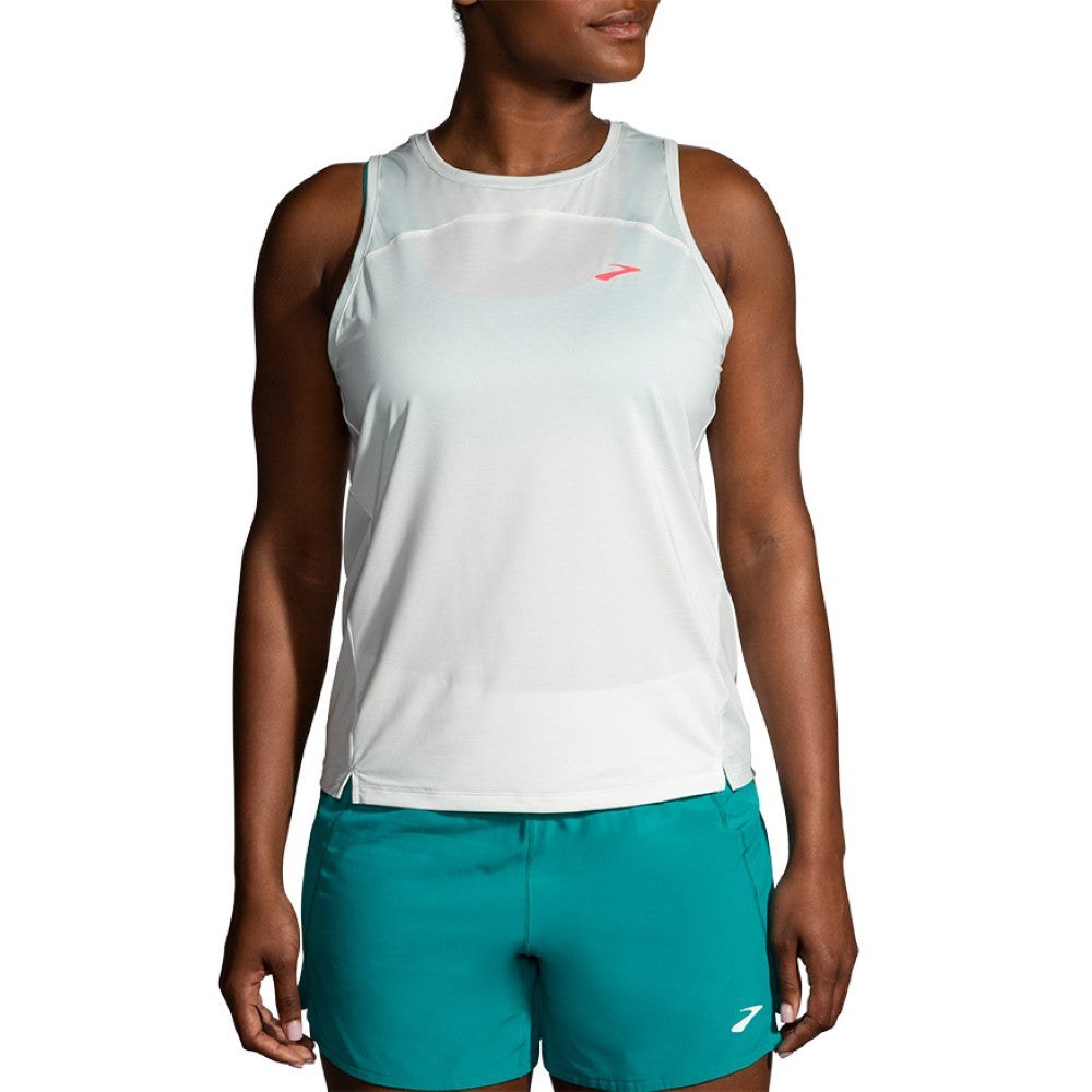 Brooks Sprint Free Tank 2.0 in white mint worn by female model with teal shorts